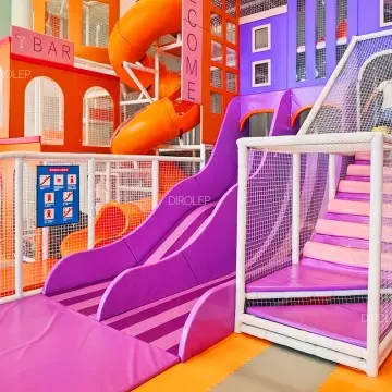 Minimalist custom Morandi indoor playground fitted with factory-made trampolines, curved slides and matte climbing equipment for malls.