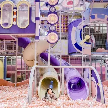 It provides a unique factory-themed experience with diverse equipment in the indoor playground, such as colorful slides and safe climb zones.